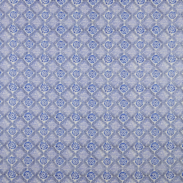 Blue batik floral cotton swatch with small repeating lattice pattern