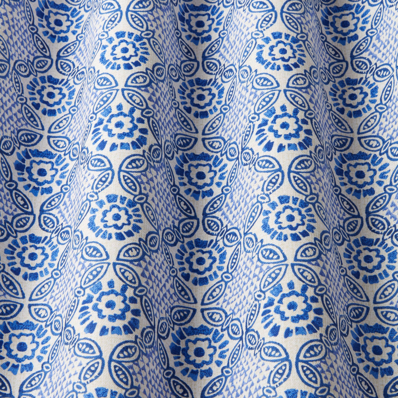Blue batik-style floral and leaf print on ivory cotton swatch