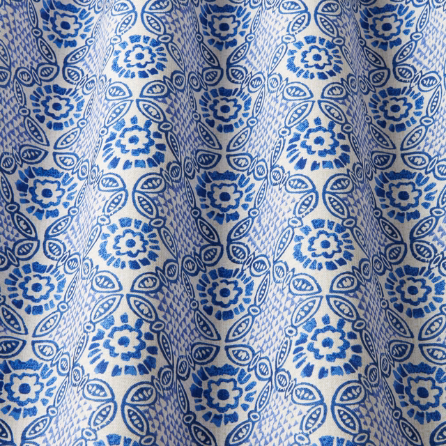 Blue batik-style floral and leaf print on ivory cotton swatch