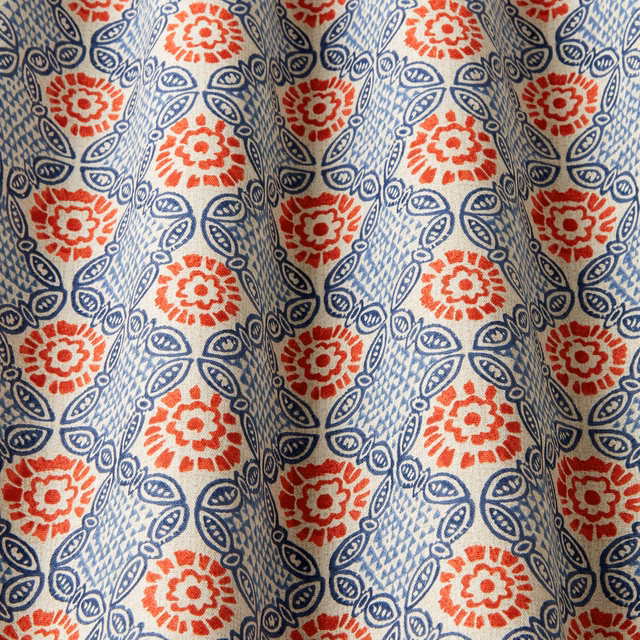 Cream cotton fabric with red floral medallions and navy linked lattice pattern