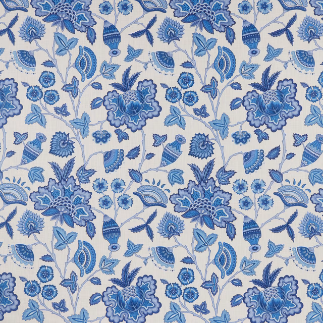 Blue botanical batik print on a pale ground with floral and leaf motifs