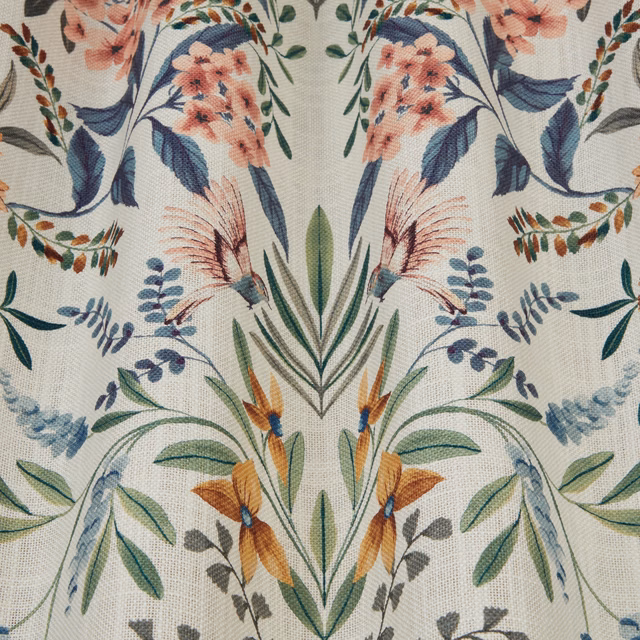 Painterly floral fabric on a chalky pale ground with blue, coral and sage motifs