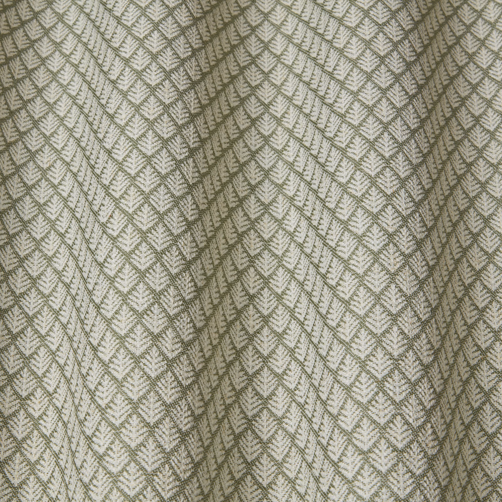 Olive green wavy geometric woven fabric on a pale ground, softly draped