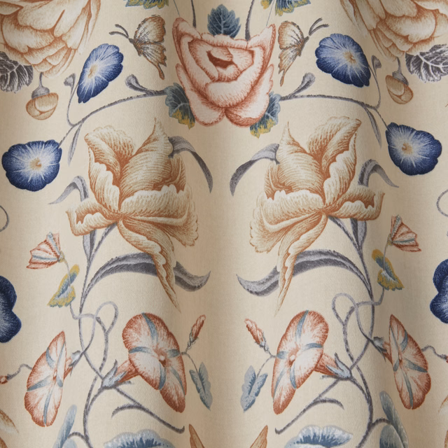 Large floral trail fabric with chalk blue blooms on an ivory ground