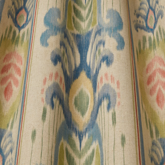 Cream fabric swatch with large blue, green and blush batik-style motifs