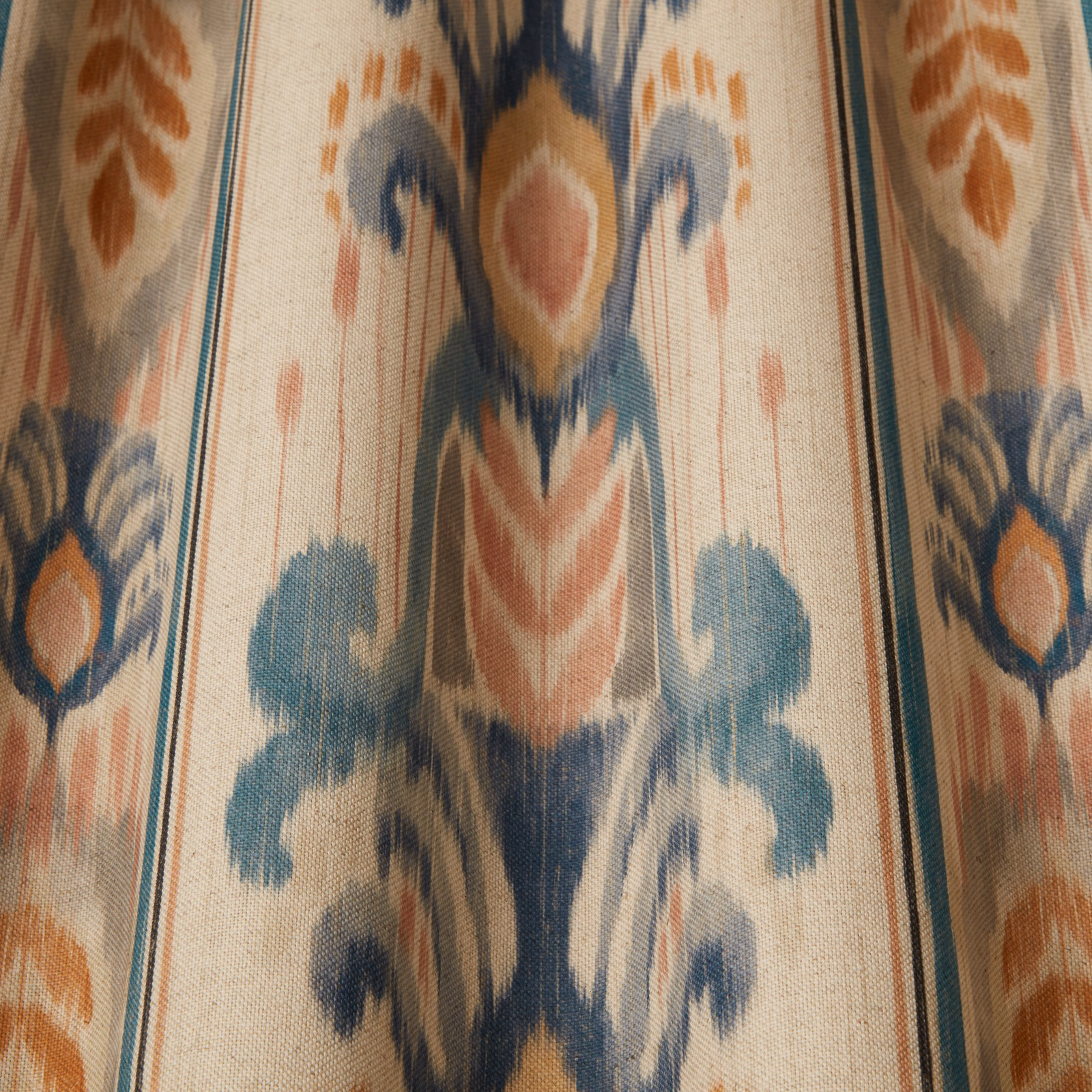 Cream woven fabric with large painterly blue and terracotta ornamental motif