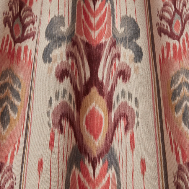 Cream fabric swatch with large ikat-style pink, berry and grey motif