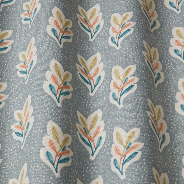 Soft chalk blue fabric with scattered leaf sprigs in cream, teal, peach and ochre