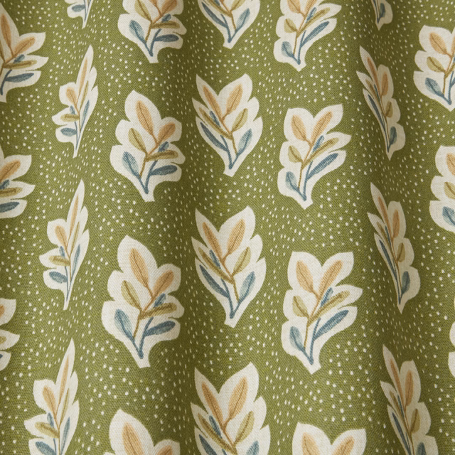 Olive green botanical fabric with cream and tan leaf motifs and dotted ground