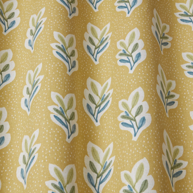 Quince yellow fabric with small leafy sprigs in white, sage and blue