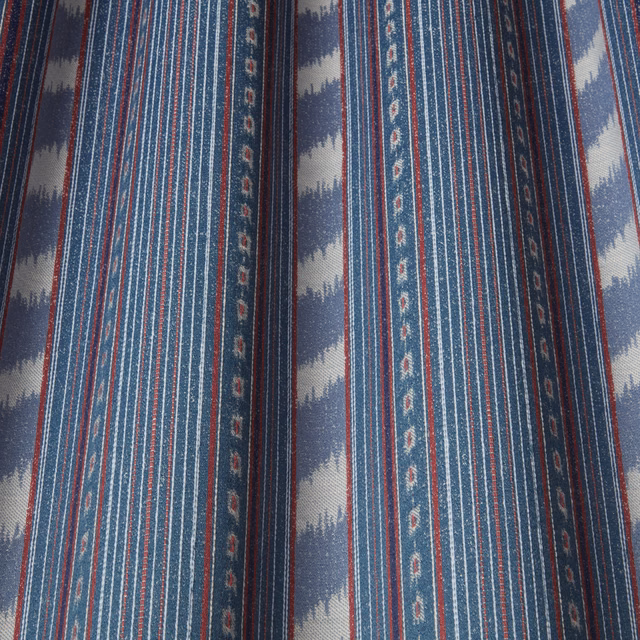Indigo striped fabric with batik-style pale wave bands and fine red accents