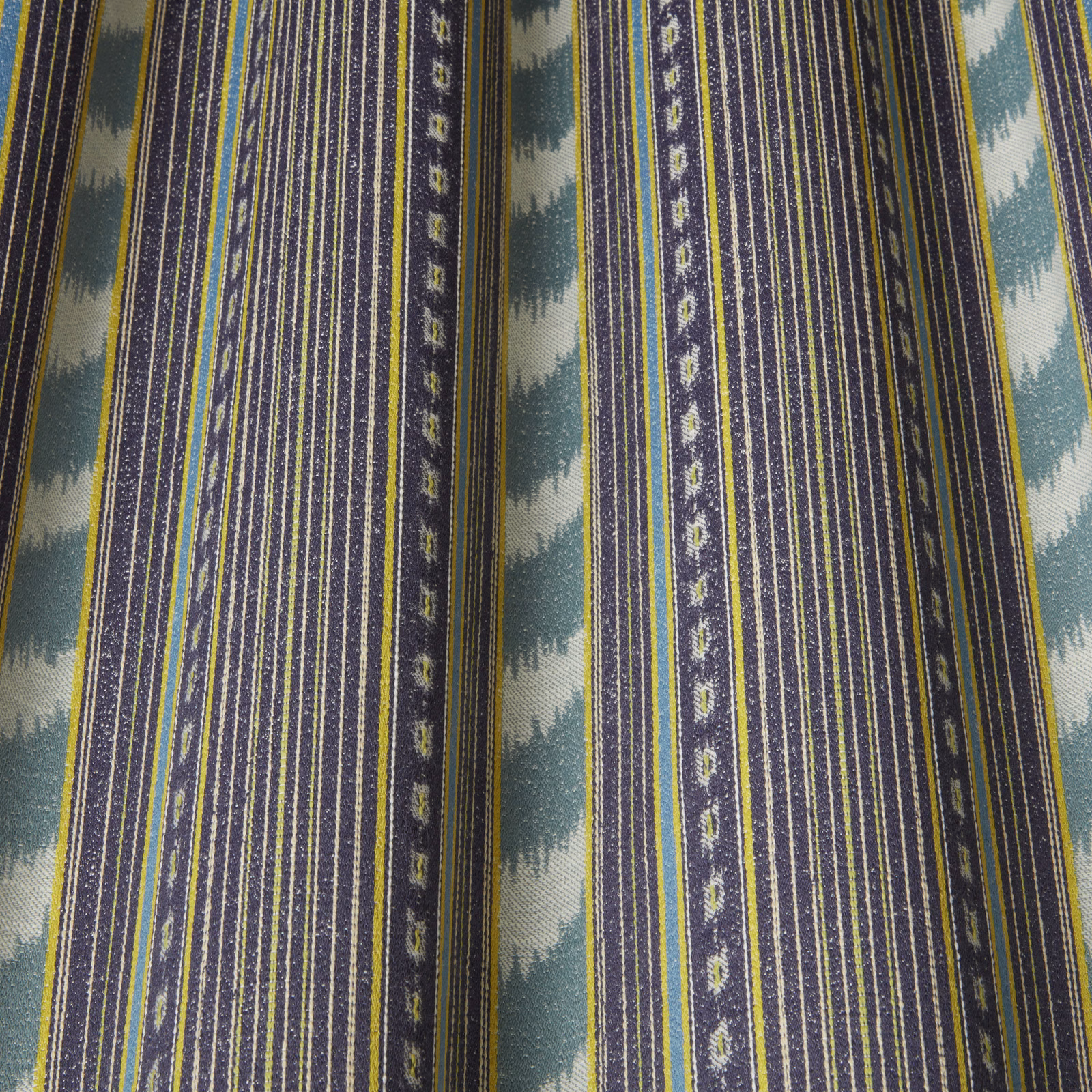 Vertical delft blue striped fabric with teal wave motif and pale accents