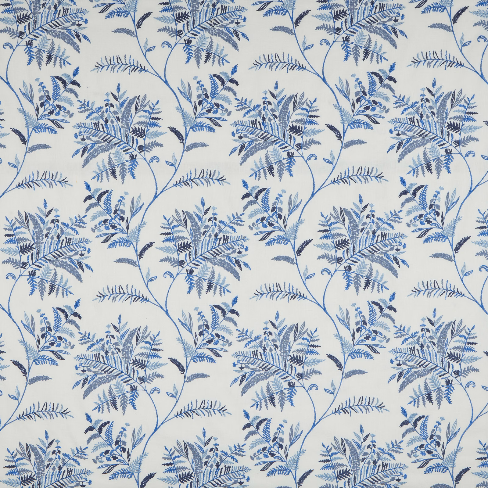 Blue botanical vine fabric with layered leaf clusters on an ivory ground