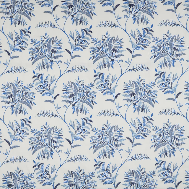 Blue botanical vine fabric with layered leaf clusters on an ivory ground