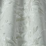 Pale sage-green botanical fabric with woven leaf motif and soft sheen