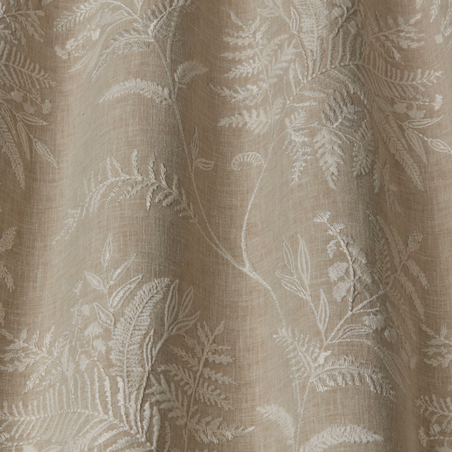 Stone beige floral fabric with raised leaf embroidery and soft linen texture