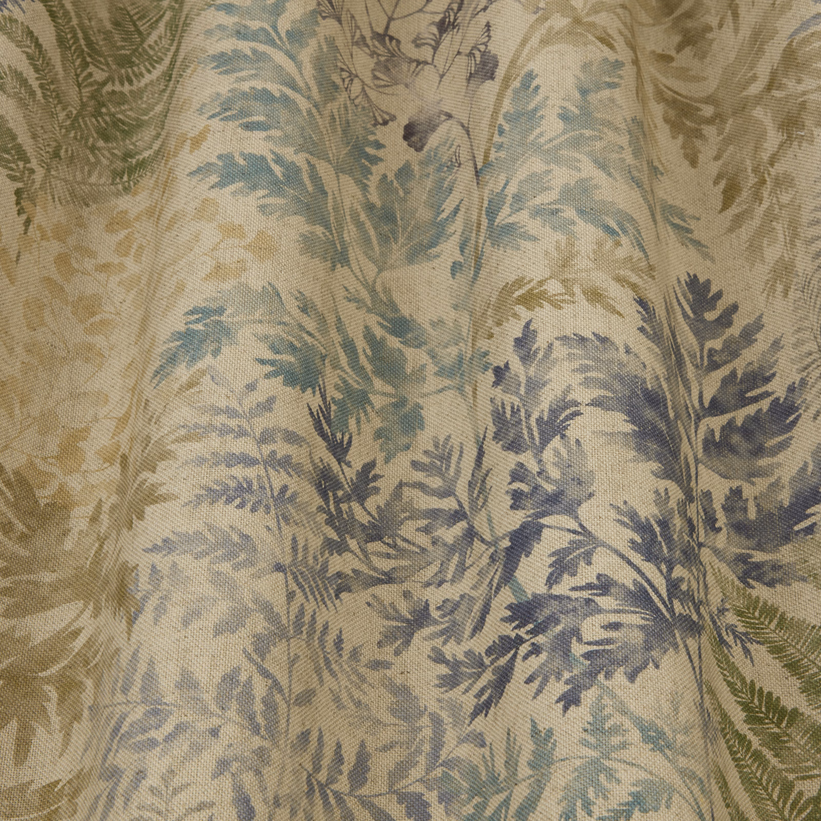 Close-up of sage and blue-green botanical print on a pale woven fabric