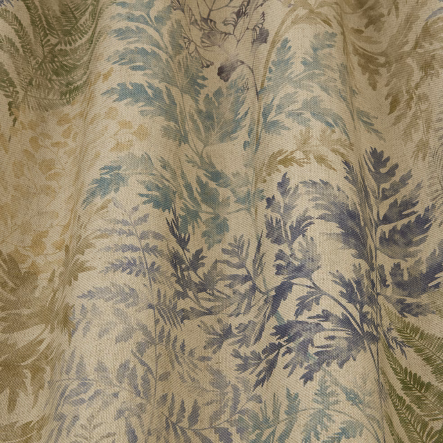 Close-up of sage and blue-green botanical print on a pale woven fabric