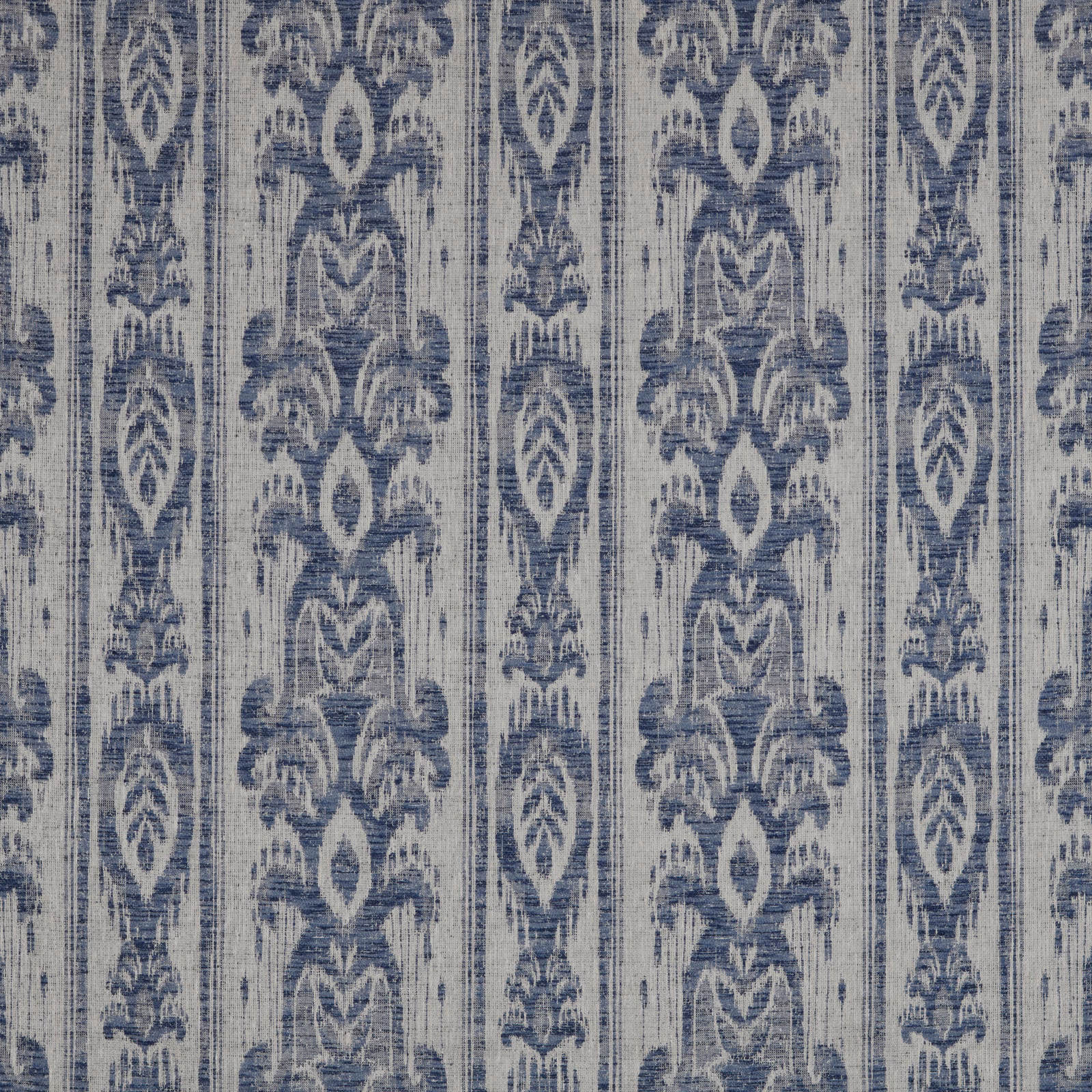 Muted denim blue batik stripe fabric with distressed vertical ornamental motifs