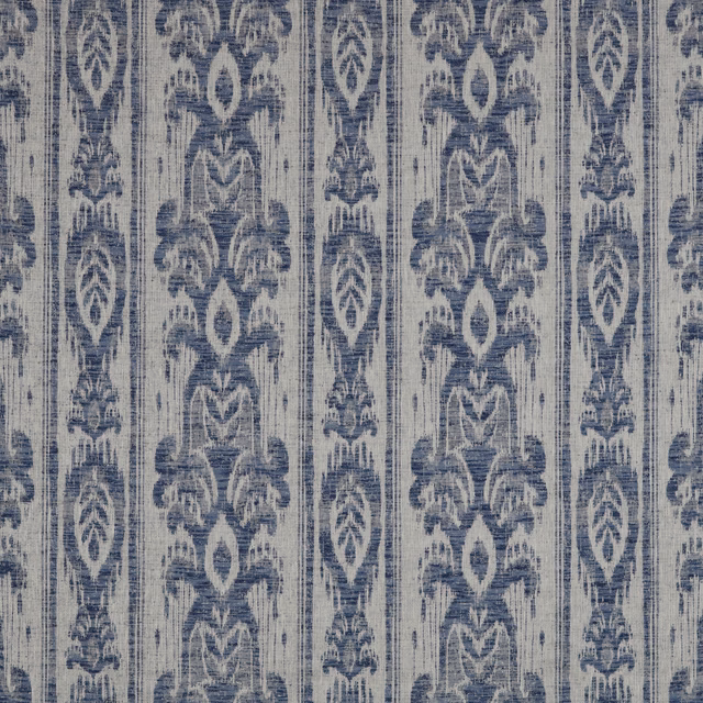 Muted denim blue batik stripe fabric with distressed vertical ornamental motifs