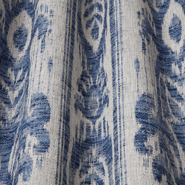 Blue and ivory batik-style fabric with wavy vertical oval motifs and textured weave