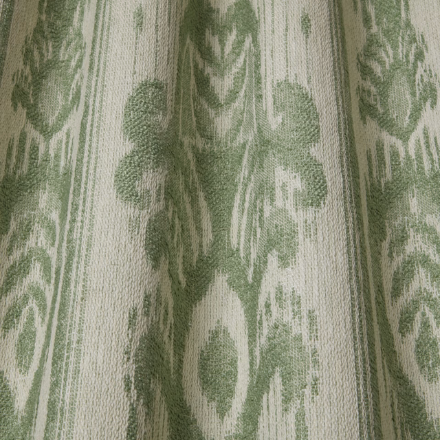 Close-up of sage green and ivory woven botanical fabric with a large repeating leaf motif
