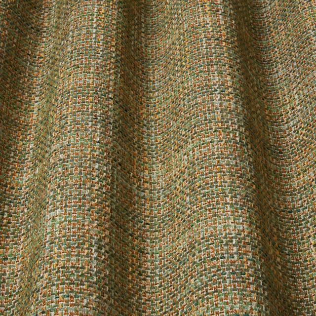 Close-up of green and amber textured woven fabric with small wavy pattern