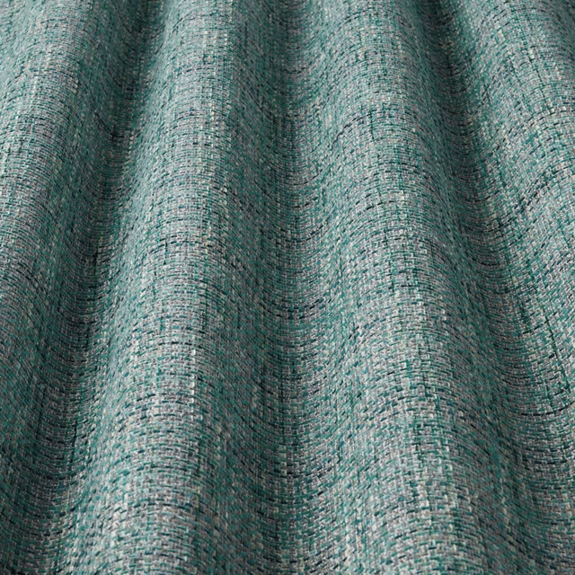 Jade teal woven fabric with large wavy vertical folds and textured slub surface