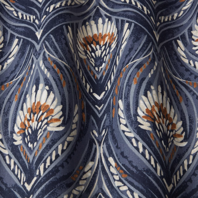 Close-up of a deep blue wavy leaf pattern with ivory and rust accents