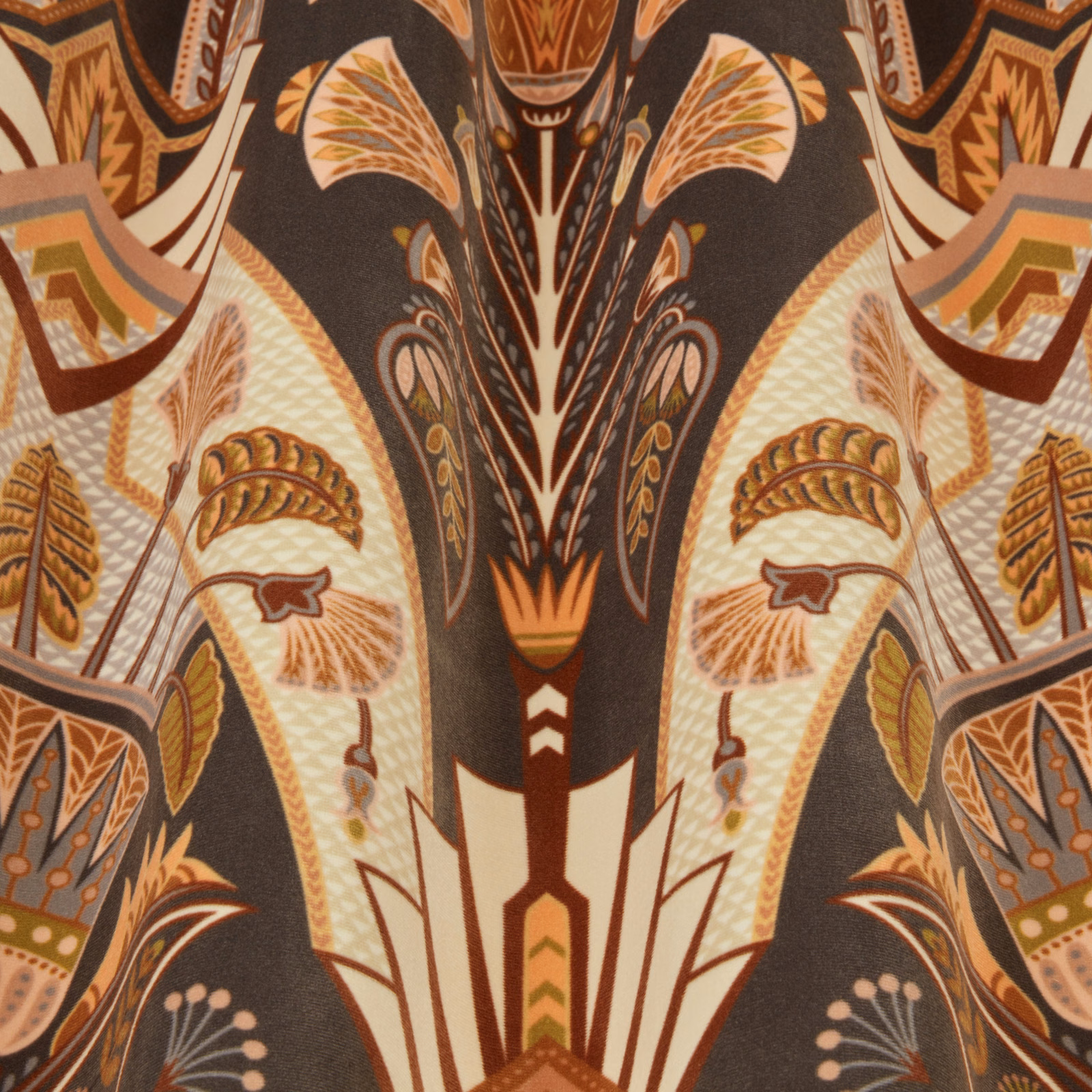 Art Deco style fabric swatch with amber, cream and cocoa leaf motifs on a dark ground