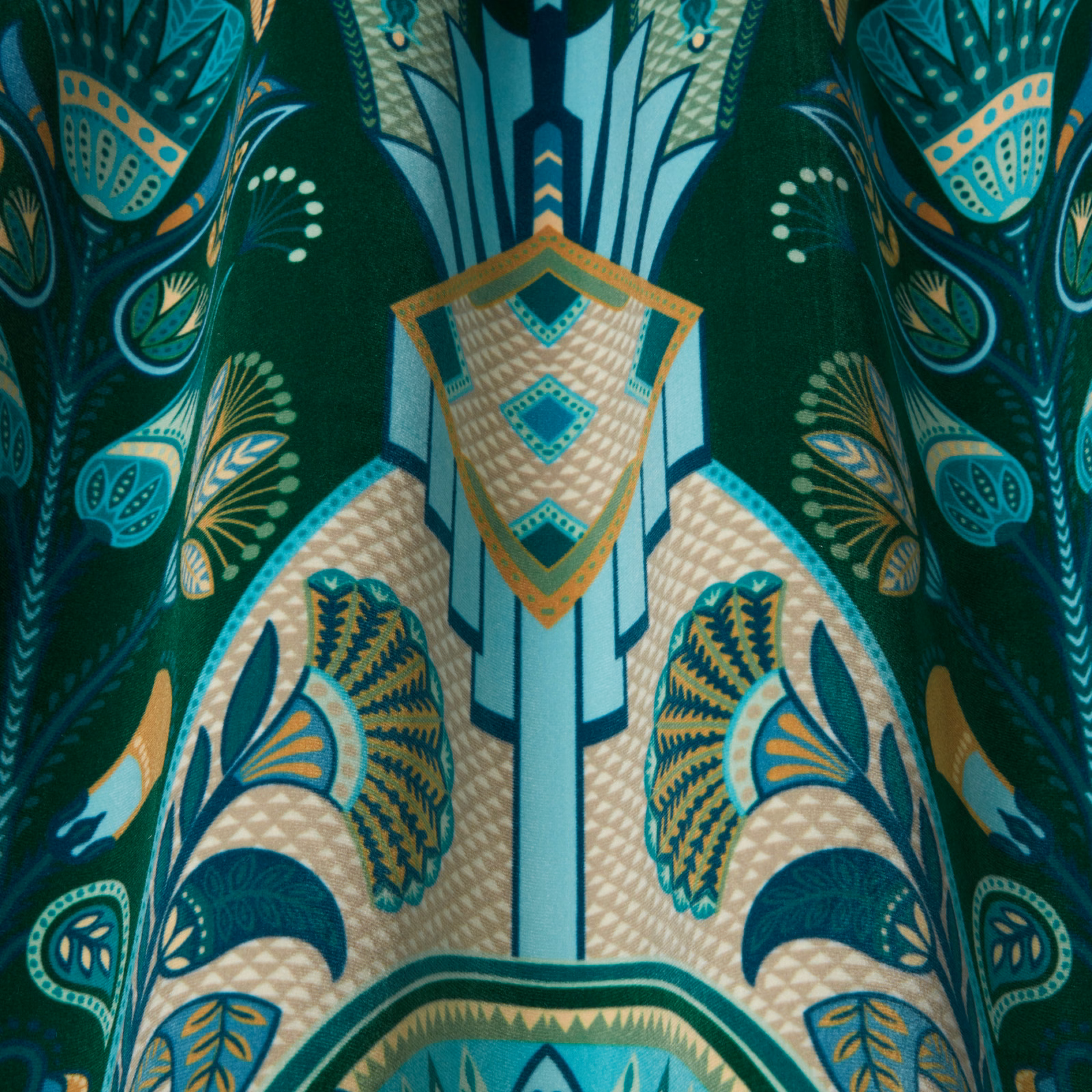 Emerald green patterned fabric with aqua and gold wavy motifs, shown as a swatch