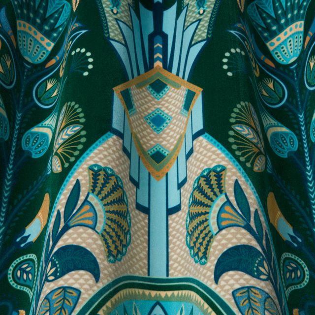 Emerald green patterned fabric with aqua and gold wavy motifs, shown as a swatch