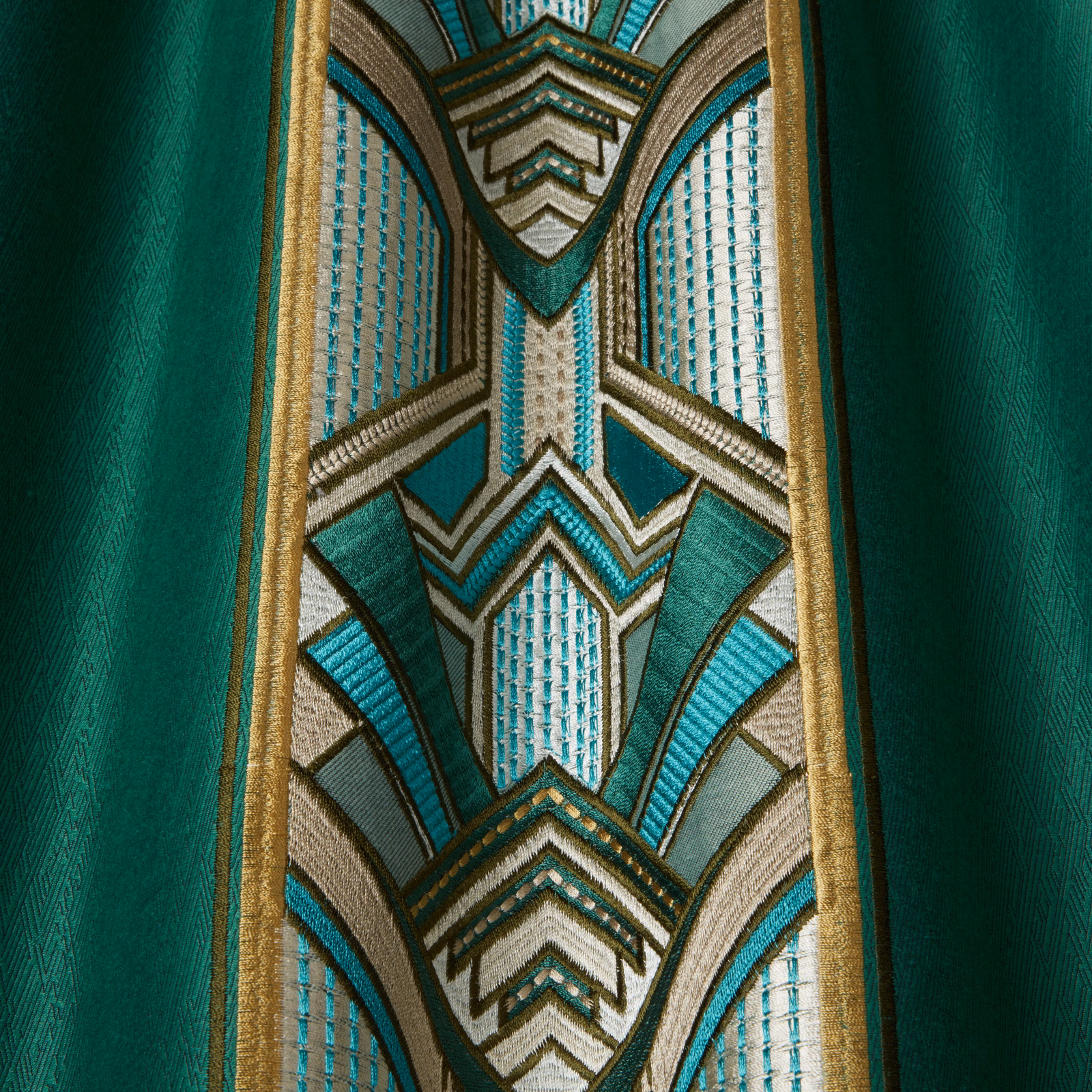 Emerald green fabric swatch with Art Deco geometric stripe in teal, cream and gold
