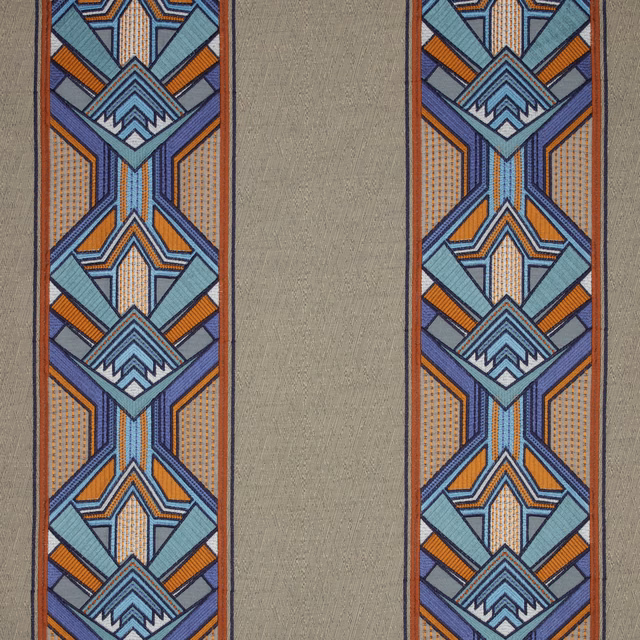 Taupe fabric swatch with bold geometric blue, teal and orange border stripes