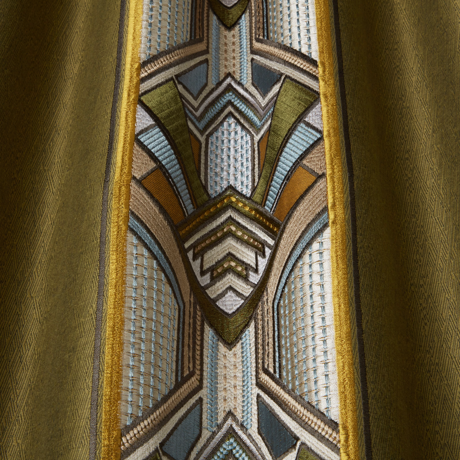 Moss green geometric woven fabric with gold borders and blue-grey accents