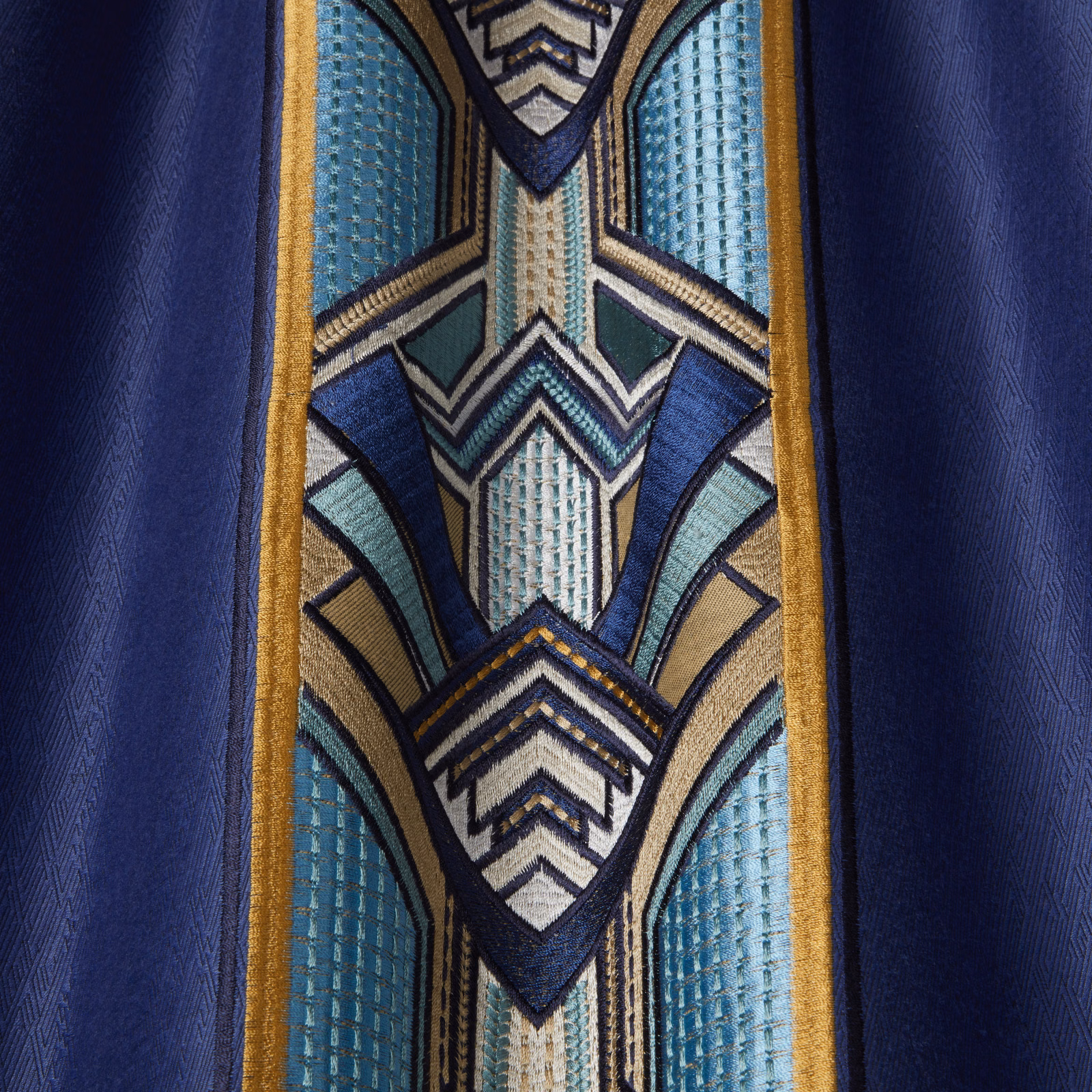 Sapphire blue geometric drapery fabric with teal, ivory and gold detailing