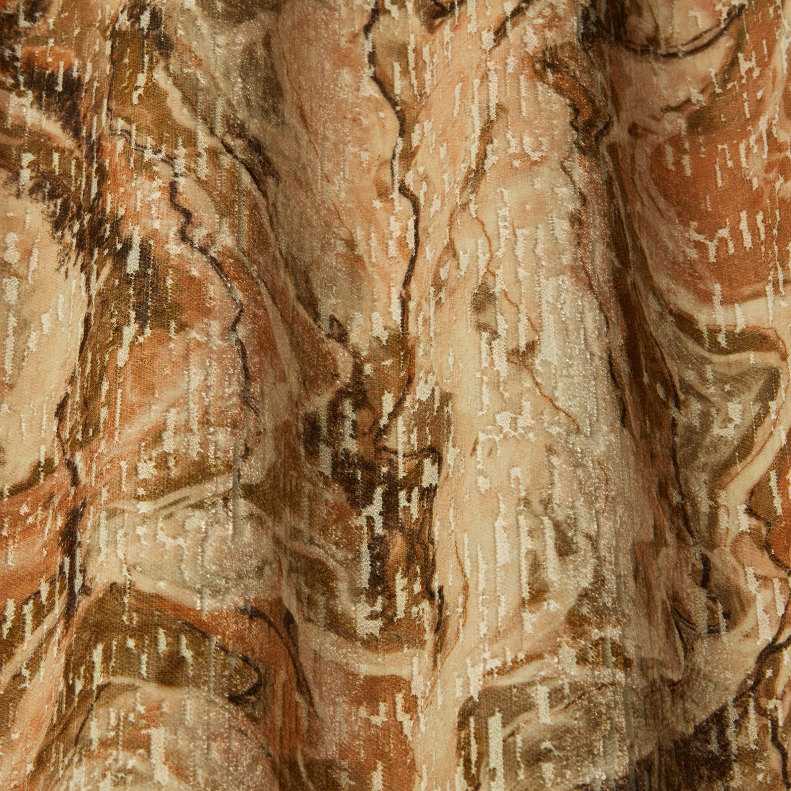 Marbled amber and terracotta drapery fabric with flowing wavy streaks