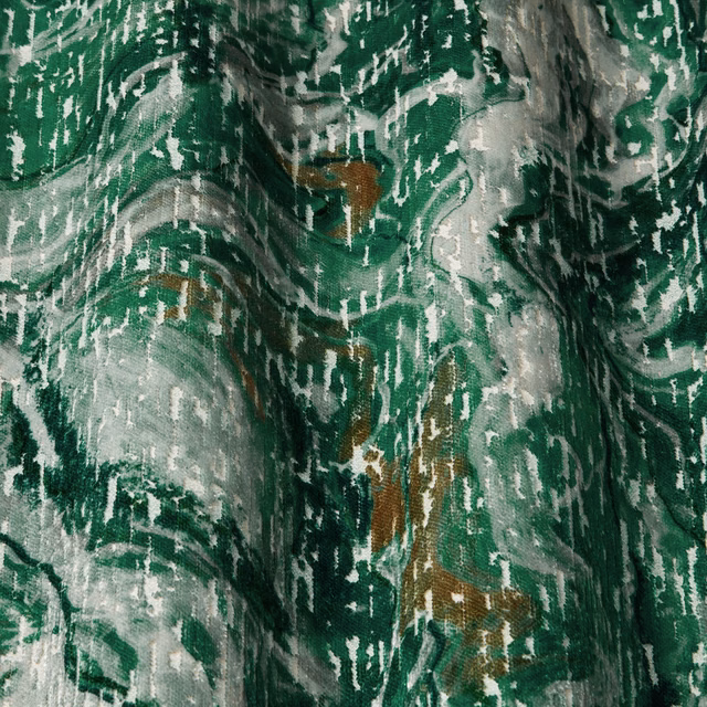 Emerald green abstract woven fabric with silver-grey and brown accents in soft folds