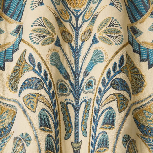 Cream embroidered fabric with moss, teal and gold botanical pattern