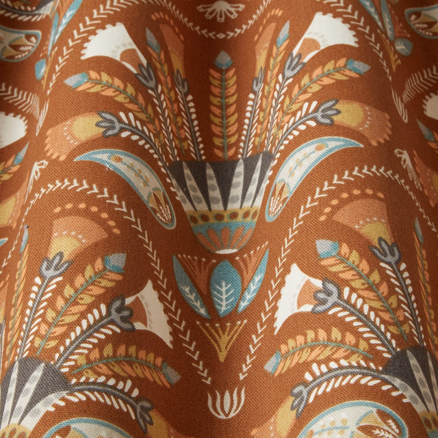 Amber terracotta patterned fabric with ivory, teal and charcoal wavy motifs