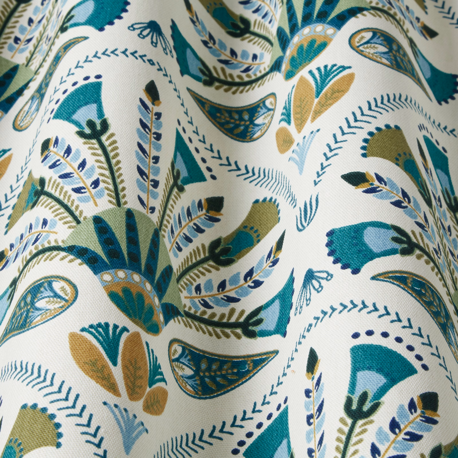 Emerald teal botanical patterned fabric with blue and gold leaf motifs on ivory