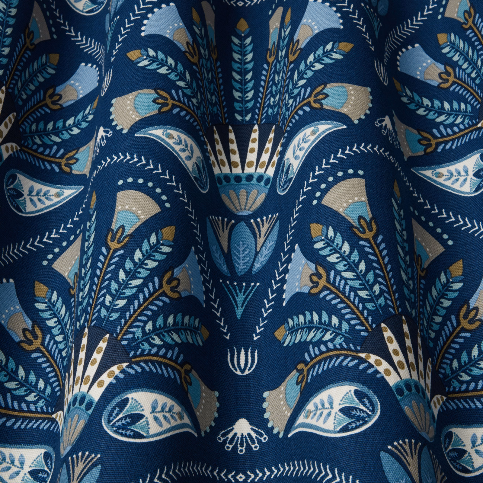 Deep sapphire fabric with large stylised leaf and fan motif in blue, ivory and taupe