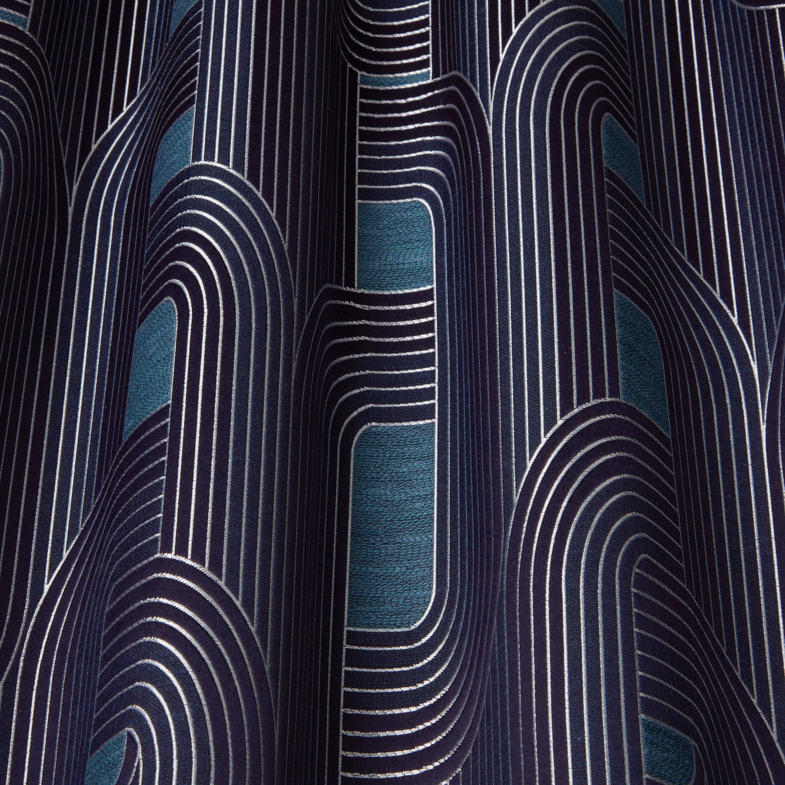 Dark navy fabric with teal arch motifs and fine ivory vertical stripes