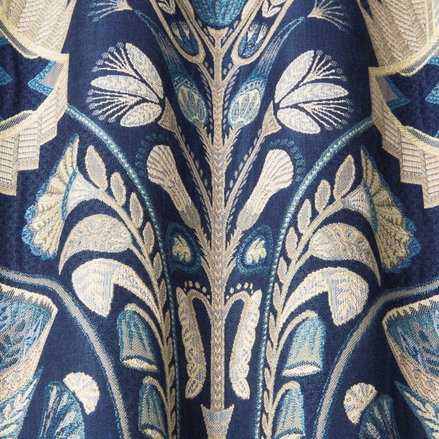 Deep sapphire woven fabric with pale cream and aqua botanical leaf pattern