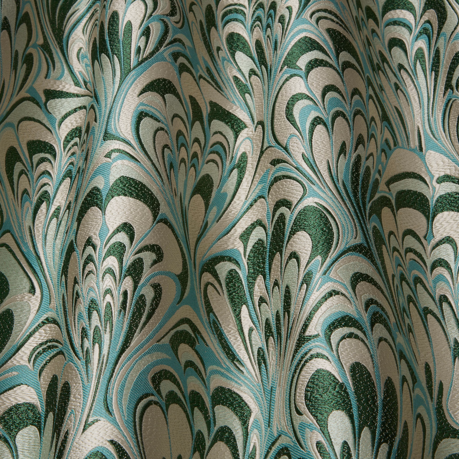 Emerald and aqua abstract feathered fabric on a pale ivory ground