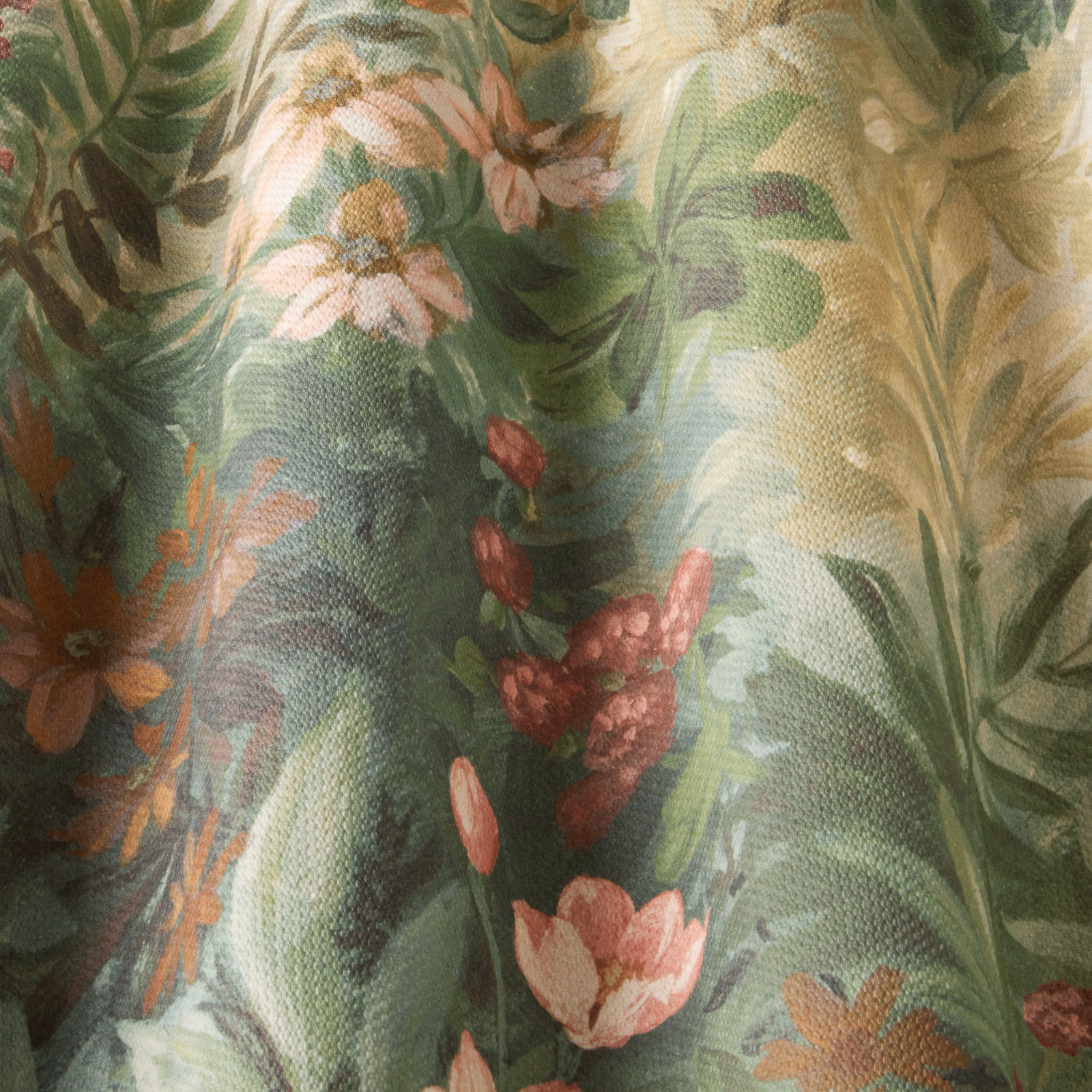 Painterly green botanical cotton with pink and peach flowers on a textured weave