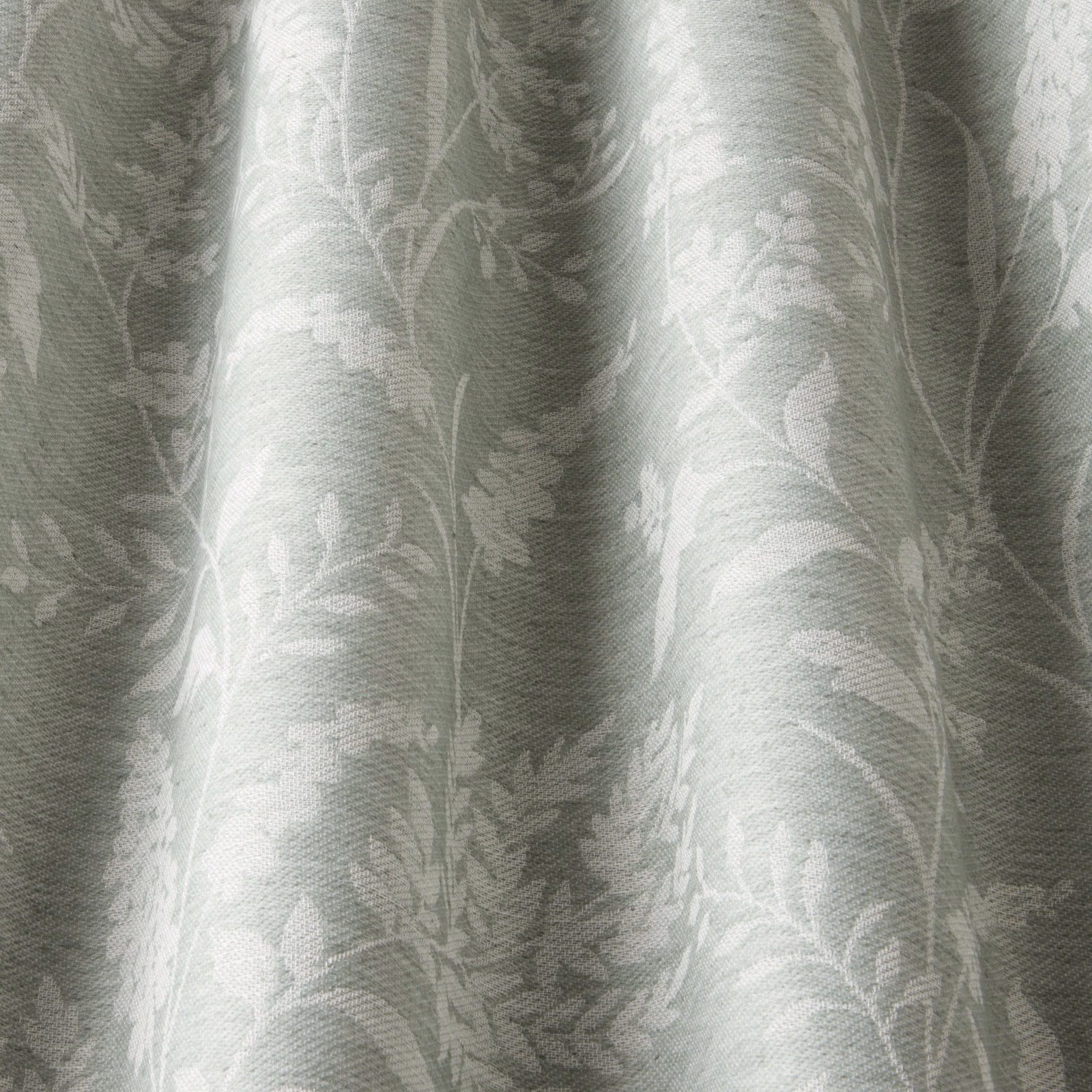 Pale sage botanical fabric swatch with soft wavy leaf pattern and tonal weave