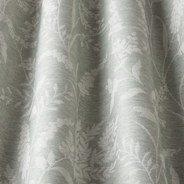 Pale sage botanical fabric swatch with soft wavy leaf pattern and tonal weave