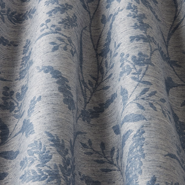 Cornflower blue wavy botanical cotton fabric on a pale ground