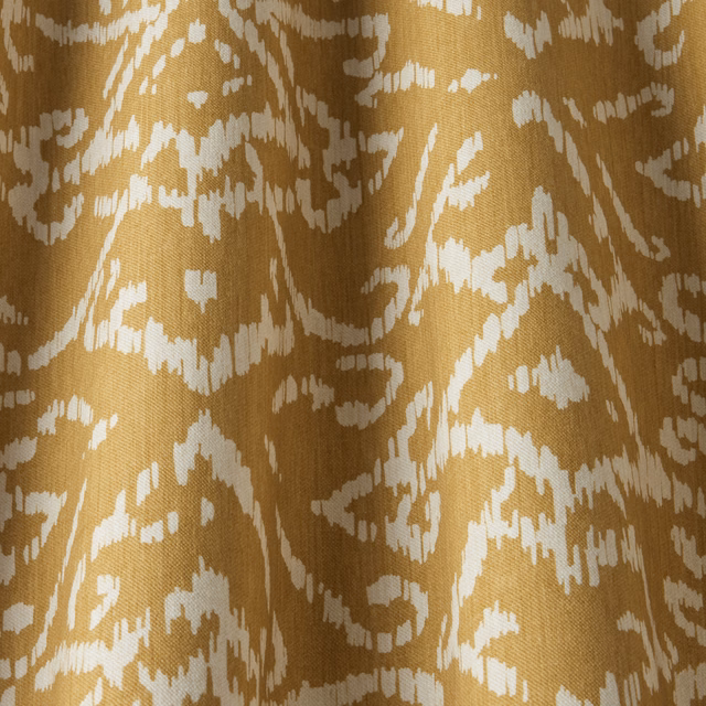 Golden cotton fabric with wavy ivory lattice pattern and visible woven texture
